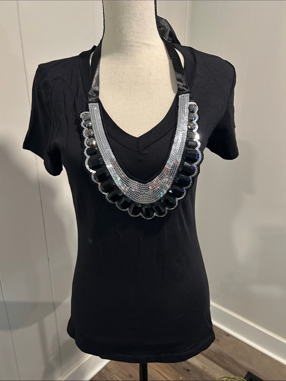 Romeo & Juliet Couture Black and Silver Sequin Bib Necklace attached on shirt